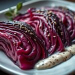 moody close-up of charred red cabbage wedges drizzled with creamy tahini and za’atar herbs, shot in dramatic side-light. moody close-up of charred red cabbage wedges drizzled with creamy tahini and za’atar herbs, shot in dramatic side-light.